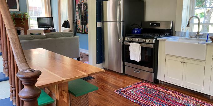 Kitchen with harvest table and view into the living room
